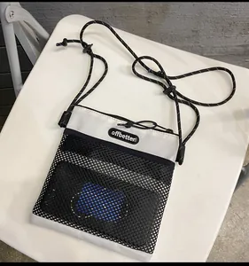 Detail of minimalist nylon mesh shoulder bag with offbetter logo and drawstring closure