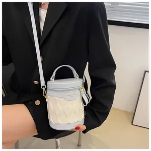 Detail of blue and beige bucket bag with wave texture and metal zipper closure