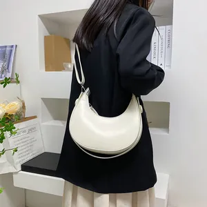 Minimalist cream white half-moon crescent shoulder bag with adjustable strap and PU leather