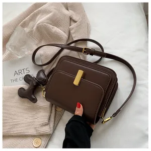 Deep brown retro small square crossbody bag with gold buckle and cute dog charm detail
