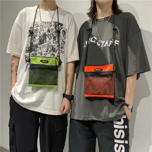 Minimalist nylon crossbody bag set in fluorescent green and bright orange with mesh pockets