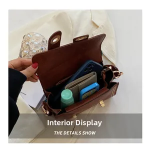 Detailed interior of vintage brown shoulder bag showing daily essentials storage