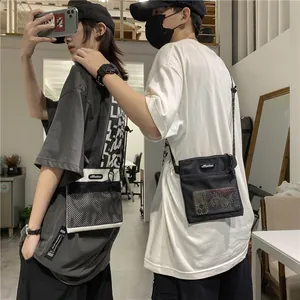 Minimalist nylon crossbody messenger bag with mesh pocket and zip closure in urban style