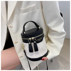Detail of contrast color bucket bag with quilted texture and gold-tone hardware