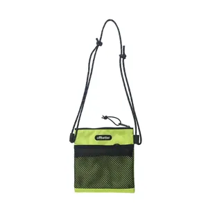 Neon green nylon crossbody bag with black mesh pocket and adjustable shoulder strap
