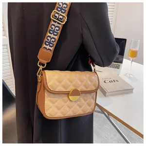 Detail of vintage rhombic quilted crossbody bag with stylish wide jacquard shoulder strap