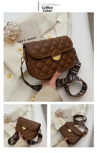 Detail of coffee brown quilted crossbody bag with stylish geometric jacquard strap