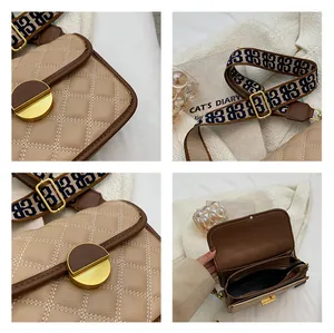 Close-up of beige quilted crossbody bag showing metal lock, wide strap and inner pockets