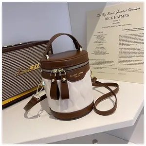 Detailed view of bicolor bucket bag with wave quilting and vintage hardware accents