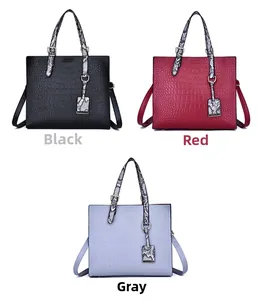 Three tote bags in black, red, and grey with faux crocodile texture and snakeskin handles