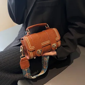 Retro dark brown cylinder shoulder bag with gold rivets and ethnic printed wide strap