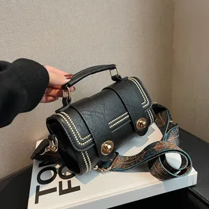 Retro black cylinder crossbody bag with gold rivets and colorful ethnic wide strap