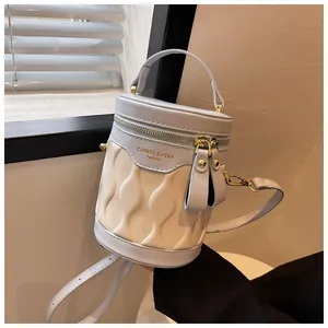 Detail of color-block bucket bag with wave quilted pattern and dual zippers