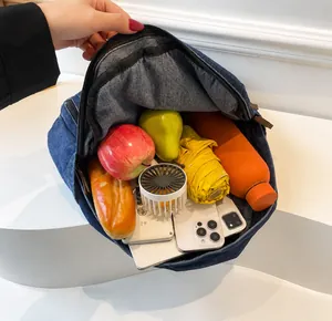 Detailed interior view of a spacious denim backpack showing high storage capacity