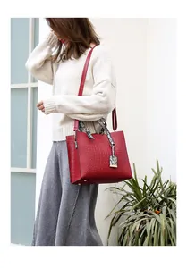 Deep red crocodile embossed tote bag with snakeskin print scarf on handle and shoulder strap
