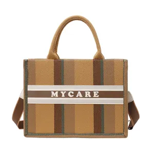 Grande borsa tote in tela a righe color terra con manici e tracolla rimovibile