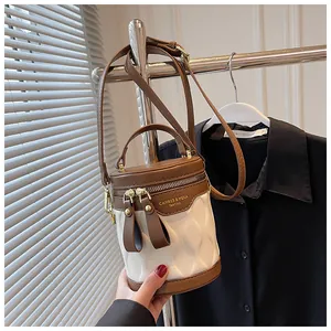 Detail view of contrast bucket bag with wave texture and dual metal zippers