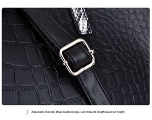 Detail of adjustable shoulder strap with gold buckle on black crocodile pattern tote