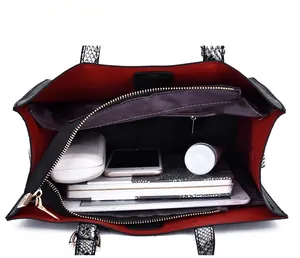 Interior view of large tote bag with red lining showing organized storage compartments
