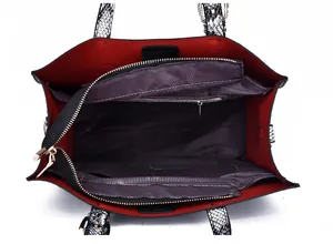 Detail view of large tote interior with contrast red lining and triple compartment storage