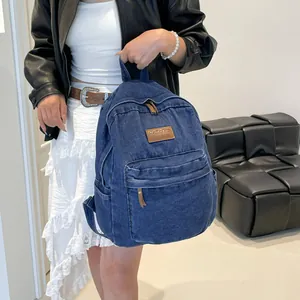 Fashionable dark blue denim backpack with brown leather patches for stylish girls