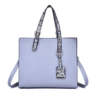Elegant blue crocodile pattern tote bag with snake print handles and adjustable strap