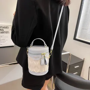 Fashionable two-tone bucket bag with wavy texture and light blue details shown on a model