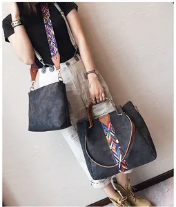 Detail of dark grey matte tote set featuring vibrant bohemian woven wide shoulder strap