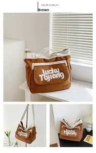 Dettaglio della grande borsa tote in tela marrone e crema con stampa Lucky Tujiang e tasca