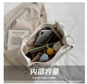 Detailed interior of minimalist large tote bag showing zipper pocket and phone slots