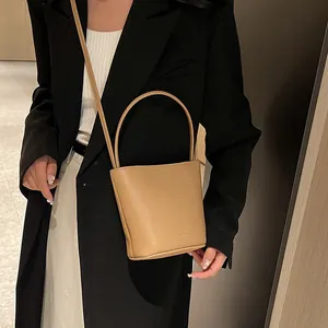 Litchi pattern leather bucket bag in camel brown with top handle and shoulder strap