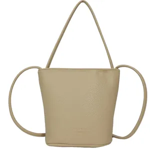 Chic beige lychee grain bucket bag with drawstring strap and textured finish