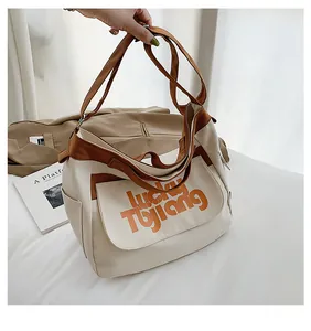 Dettaglio di una grande borsa in tela con bordo marrone e stampa Lucky TUJIANG