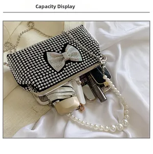 Internal capacity of the black rhinestone evening bag with pearl handle and bow detail