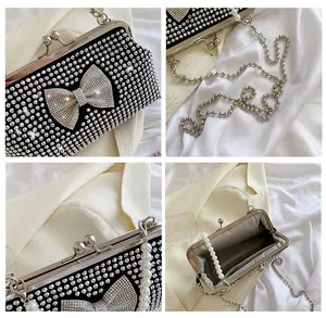 Detailed views of luxury black evening clutch with rhinestone bow and pearl handle