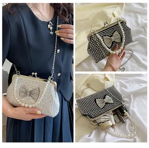Three-way view of rhinestone bow handbag showing styling and interior capacity