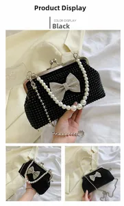 Detail of black evening bag with pearl handle and sparkling crystal bow accent