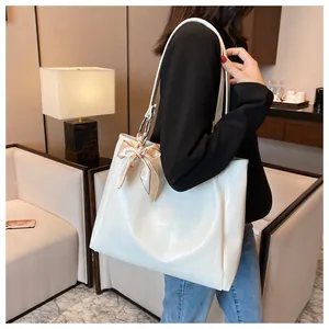White crocodile embossed tote bag with a silk scarf detail on handle for daily use