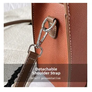 Detail of the brown lychee grain leather bag showing the detachable shoulder strap buckle