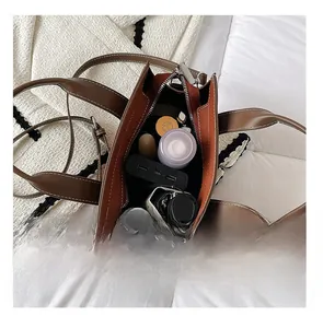 Interior view showing the large capacity of a brown pebbled leather tote bag for essentials