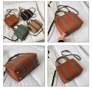Detail showing contrast straps and base feet on leather tote bags in four colors