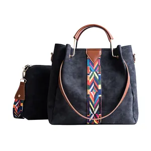 Minimalist grey bucket bag set with colorful ethnic woven straps and brown leather handles