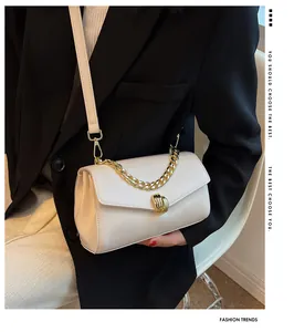 Detail of off-white leather bag featuring golden twist lock and chunky chain strap