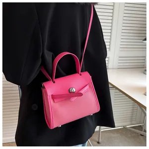 Dettaglio borsa a mano rosa in pelle con trama a litchi e fibbia in metallo argento