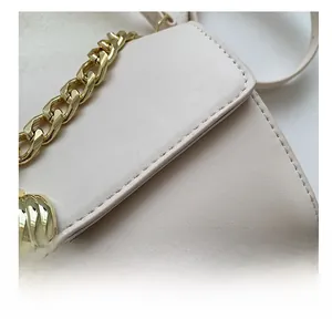 Detailed close-up showing precise stitching on vintage textured beige leather bag