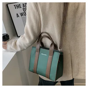 Litchi texture leather tote bag in green and brown on a model for lifestyle display