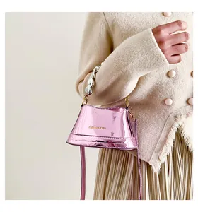Dettaglio mini borsa a secchiello in vernice rosa con manico a cuore in perle argento