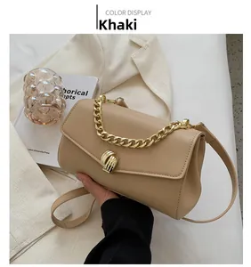 Detail of khaki leather crossbody bag with chunky gold chain and twisted metal lock