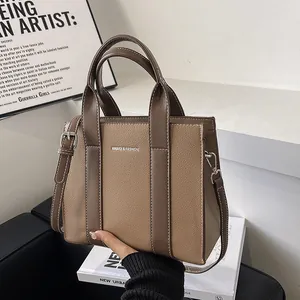 Taupe pebbled leather tote bag with silver hardware and adjustable shoulder strap