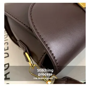 Macro shot of fine stitching craftsmanship and gold hardware on dark brown leather bag